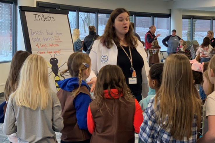 woman teaching children about insects